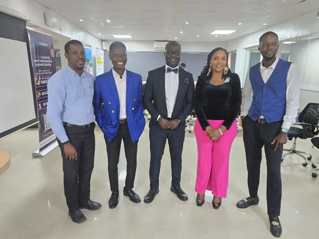 Five speakers and organisers posing together after a session